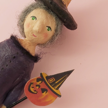 Load image into Gallery viewer, Close up front view of witch's face, and her paper jack-o-lantern. Photo 9 of 11.