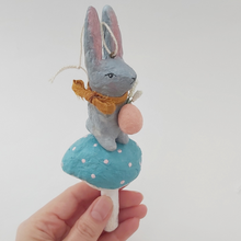 Cargar imagen en el visor de la galería, Spun cotton Easter bunny on mushroom, held in hand. Pic 2 of 8.