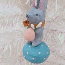 Cargar imagen en el visor de la galería, Close up of spun cotton bunny face and coral pink egg with white flowers. Pic 3 of 8.
