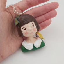 Load image into Gallery viewer, Spun cotton girl ornament next to hand, for size comparison. Pic 2 of 11.