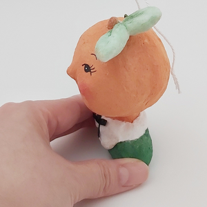Side view of peach girl ornament. Pic 4 of 9.