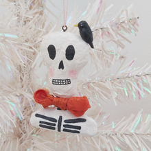 Cargar imagen en el visor de la galería, Spun cotton skeleton ornament, with black bird on head, hanging on tree. Pic 2 of 6.