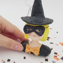 Load image into Gallery viewer, Close view of glittery bandit mask on spun cotton witch ornament. Pic 4 of 6.