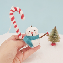 Cargar imagen en el visor de la galería, Spun cotton snowman and candy cane ornaments, held in hand for size comparison. Pic 2 of 6.
