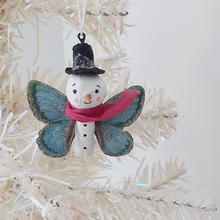 Cargar imagen en el visor de la galería, Spun Cotton Snowman Butterfly Ornament hanging from tree. Pic 1 of 5.