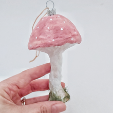 Load image into Gallery viewer, A hand holding a pink vintage style spun cotton mushroom ornament against a white background. Pic 4 of 4.