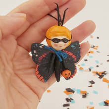 Load image into Gallery viewer, Spun cotton Halloween butterfly being held in hand for size comparison. Pic 2 of 5.