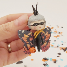 Load image into Gallery viewer, Spun cotton Halloween butterfly ornament, held in hand for size comparison. Pic 1 of 6.