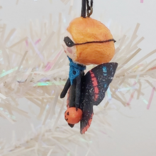 Load image into Gallery viewer, Side view of spun cotton Halloween butterfly, hanging on tree. Pic 4 of 5.