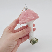 Load image into Gallery viewer, A hand holding a pink vintage style spun cotton mushroom ornament against a white background. Pic 1 of 4.