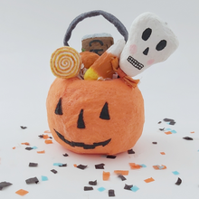 Load image into Gallery viewer, Spun cotton Halloween pumpkin bucket, holding sweets and sitting on white background with Halloween confetti. Pic 1 of 5.