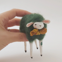 Load image into Gallery viewer, Spun cotton dark green sheep held in hand for size comparison. Pic 2 of 5.