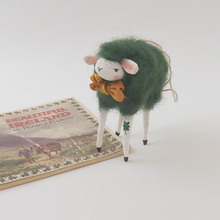 Load image into Gallery viewer, Spun Cotton dark green sheep ornament, standing next to vintage Ireland souvenir book. Pic 1 of 5.