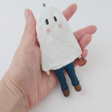 Load image into Gallery viewer, Spun cotton ghost boy ornament, held in hand for size comparison. Pic 2 of 6.