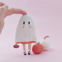 Load image into Gallery viewer, Spun cotton ghost girl ornament, standing with support in front of white and orange spun cotton pumpkins. Pic 1 of 6.