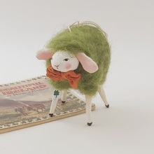 Load image into Gallery viewer, Spun cotton green wool sheep ornament, standing on vintage Ireland souvenir booklet. Pic 1 of 6.