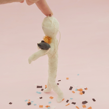 Load image into Gallery viewer, Side view of spun cotton mummy and mouse ornament, supported by hand, on Halloween confetti. Pic 6 of 8.
