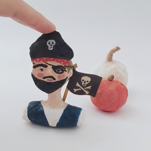 Load image into Gallery viewer, Spun cotton pirate boy ornament, sitting in front of spun cotton white and orange pumpkins. Pic 1 of 7.