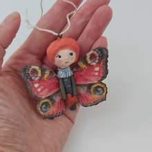Load image into Gallery viewer, Spun cotton Valentine's Day butterfly, held in hand for size comparison. Pic 2 of 4.