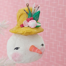 Cargar imagen en el visor de la galería, Spun cotton snowman face ornament, wearing mustard yellow top hat with glittery sweets and tinsel.