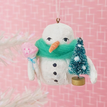Load image into Gallery viewer, Spun cotton snowman holding bottle brush tree and mushroom. Hanging from thread.