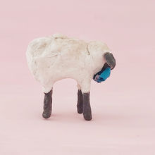 Load image into Gallery viewer, A side view of a vintage style miniature spun cotton sheep, against a pink background. Pic 6 of 8.