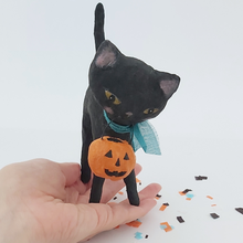 Load image into Gallery viewer, A vintage style spun cotton black cat standing on a hand, against a white background. Pic 2 of 6.