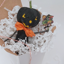 Load image into Gallery viewer, Vintage style spun cotton black jack-o'-lantern sitting in white gift box, surrounded by white tissue shredding on a white background. Pic 4 of 8.