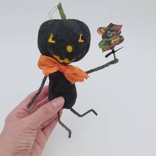 Load image into Gallery viewer, Vintage style spun cotton black jack-o'-lantern man held in hand on white background. Pic 2 of 8.