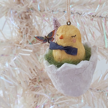 Cargar imagen en el visor de la galería, A vintage style spun cotton chick in a cracked egg ornament, hanging from a white tree. Pic 1 of 6.