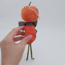 Load image into Gallery viewer, Back view of spun cotton jack-o'-lantern man, held by hand against a white background. Pic 7 of 8.