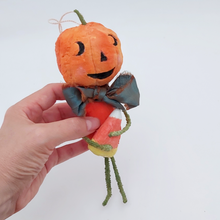 Load image into Gallery viewer, Vintage style spun cotton jack-o'-lantern man held in hand on white background. Pic 5 of 8.