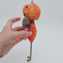 Load image into Gallery viewer, Side view of spun cotton jack-o'-lantern man, held by hand against a white background. Pic 6 of 8.