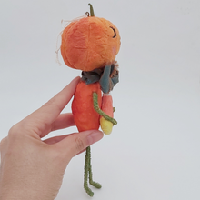 Load image into Gallery viewer, Opposite side view of spun cotton jack-o'-lantern, held in hand against white background. Pic 8 of 8.