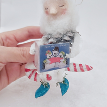 Load image into Gallery viewer, Close up of the vintage style snowman Christmas card the spun cotton pine cone elf is holding. Pic 8 of 10.