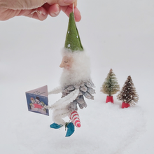 Load image into Gallery viewer, Opposite side view of vintage style spun cotton pine cone elf sitting on a spun cotton candy cane. Pic 6 of 10.