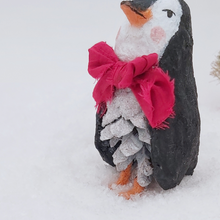 Load image into Gallery viewer, Close-up of the penguin&#39;s glittery white pine cone body and red bow tie. Pic 6 of 10. 
