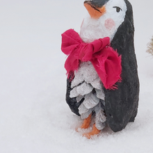 Load image into Gallery viewer, Close-up of the penguin's glittery white pine cone body and red bow tie. Pic 6 of 10.