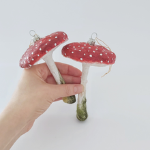 Load image into Gallery viewer, Two vintage style spun cotton red mushroom ornaments, held in hand. Pic 5 of 5.