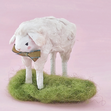 Load image into Gallery viewer, A vintage style spun cotton sheep standing on green wool grass, against a pink background. Pic 1 of 8.