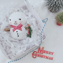 Load image into Gallery viewer, Vintage style spun cotton snowman laying in white gift box with white tissue shredding, next to two bottle brush trees and on a white background. Pic 5 of 7.
