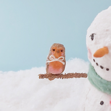 Load image into Gallery viewer, Another close-up of the spun cotton robin sitting on the snowman's arm. Pic 4 of 7.