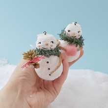 Load image into Gallery viewer, Vintage style spun cotton snowman and snow lady, held in hand for size comparison, against a light blue background. Pic 2 of 11.