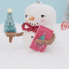 Load image into Gallery viewer, Close up of vintage style tinsel box the spun cotton snowman is holding. It sits against a light blue background, on fake snow. Pic 4 of 8.
