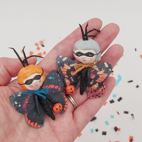 spun cotton butterfly Halloween ornaments, held in hand