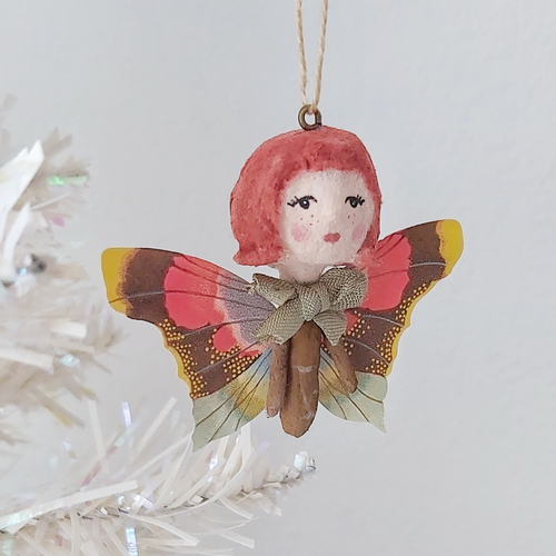 Vintage style spun cotton ginger butterfly girl, hanging on white tree against a white background. Pic 1 of 7. 