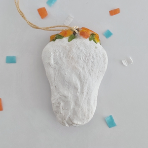 A back view of a spun cotton sugar skull ornament, on a white background. Pic 5 of 5. 