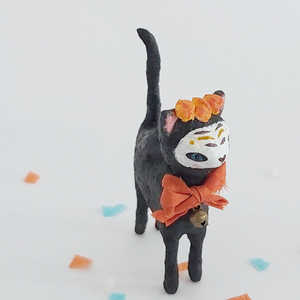A slight side view of a vintage style spun cotton Day of the Dead black cat, against a white background. Pic 3 of 9. 