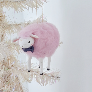 A cotton candy pink needle felted sheep ornament, hanging from a white tree. Pic 3 of 8. 