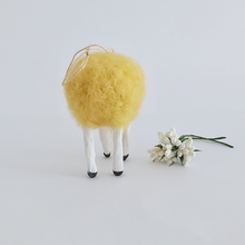 Load image into Gallery viewer, A back view of a yellow, vintage style spun needle felted spun cotton sheep ornament. White flowers sit next to her, against a white background. Pic 7 of 7. 
